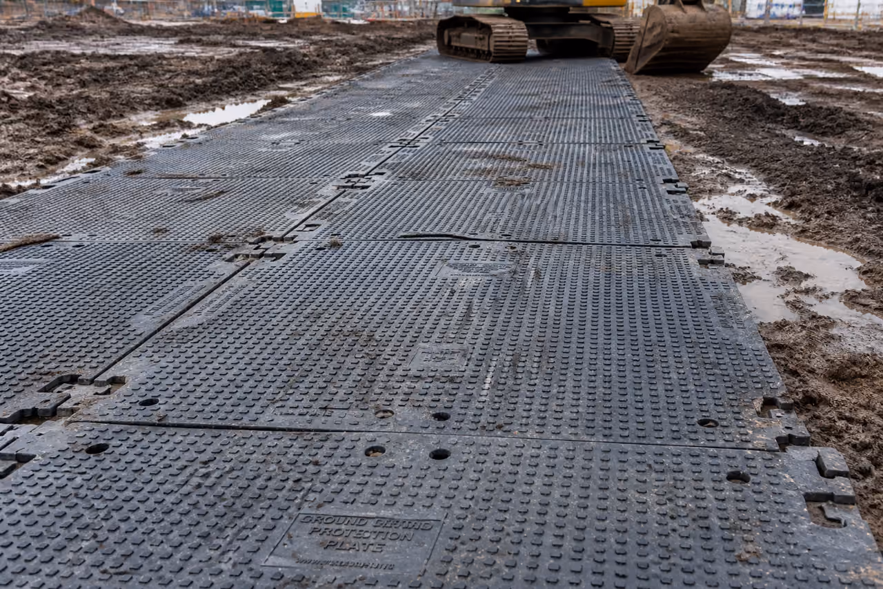 Heavy Duty Plastic Track Mats on Muddy Construction Site