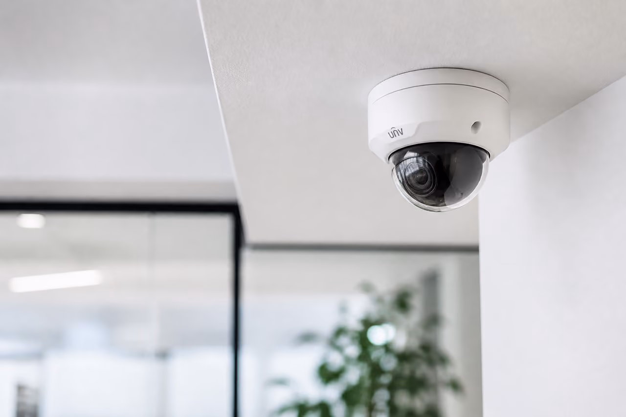 Modern White Ip 1080p Camera Mounted on Office Ceiling