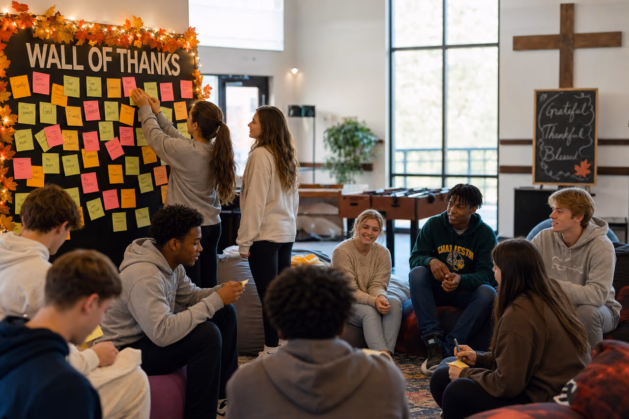 Diverse Youth Group Creating a Gratitude Wall in a Church