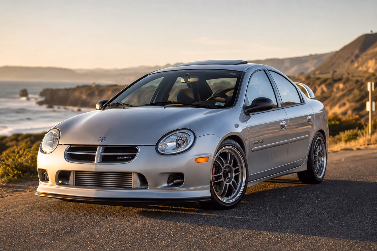 Silver 2001 Dodge Turbo Modified Compact Car on Coastal Road
