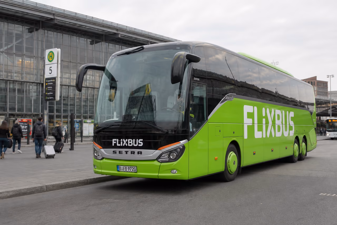 Green Intercity Bus Parked at a Modern European Terminal