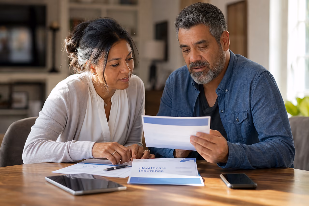 Couple Reviewing Health Insurance Documents at Home