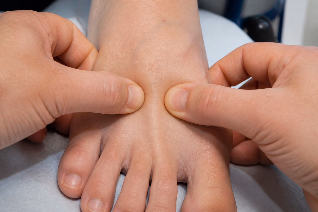 Physician Performing Mulder's Sign Examination on a Patient's Foot