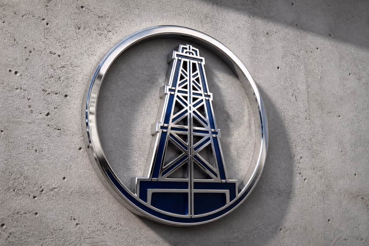 Polished Chrome Oil Derrick Symbol on Concrete Wall