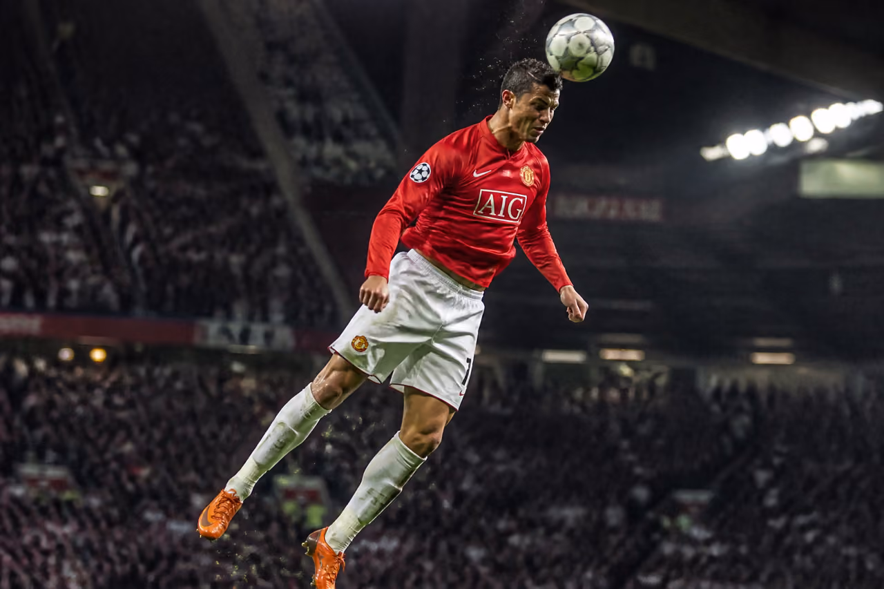 Professional Soccer Player Jumping for a Header in a Stadium