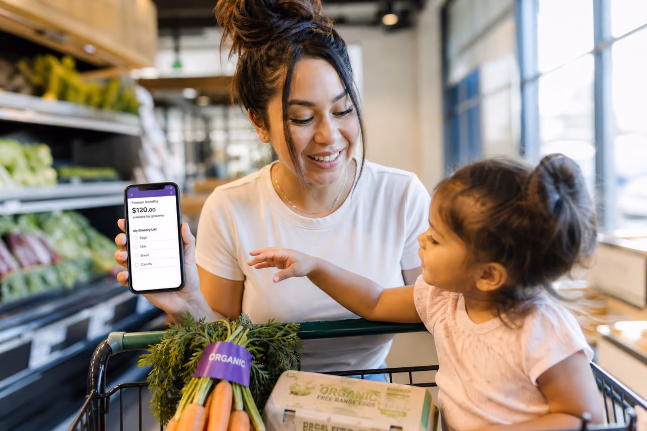 Mother and Toddler Shopping for Fresh Produce with Benefit App