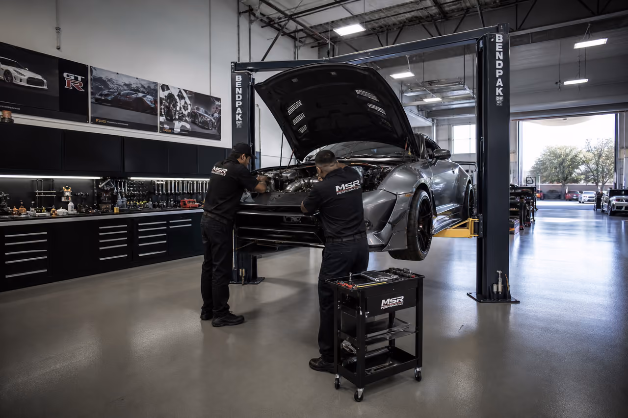 Mechanics Tuning a Performance Sports Car in a Modern Garage