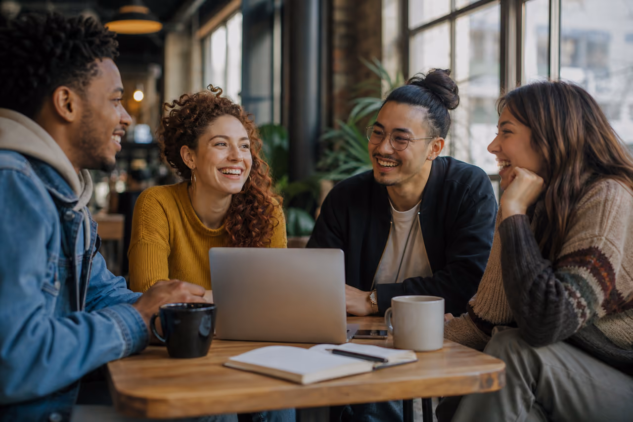Diverse Friends Laughing and Talking in a Sunny Cafe