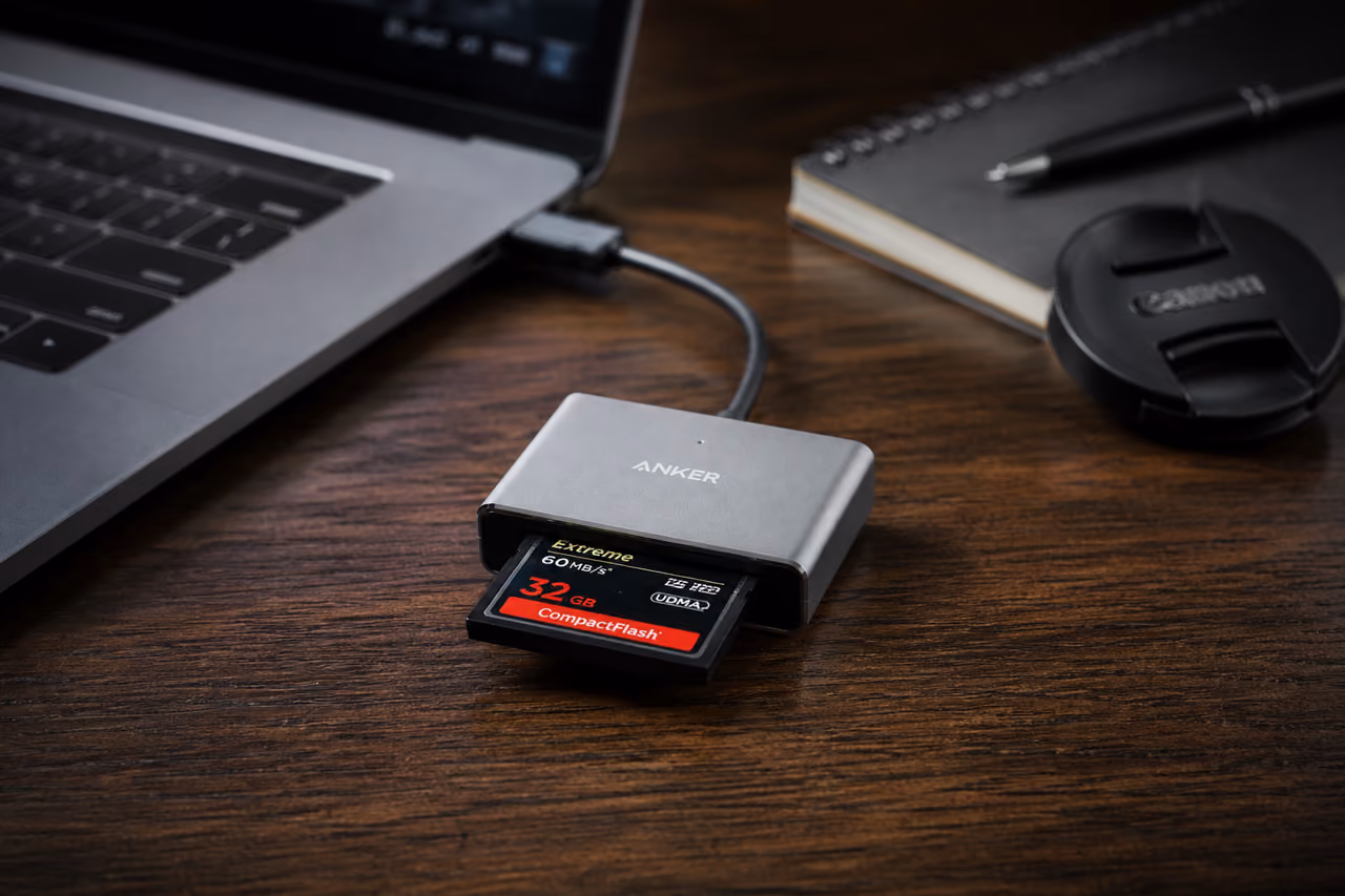 Compactflash Card Reader Connected to Laptop on Wooden Desk