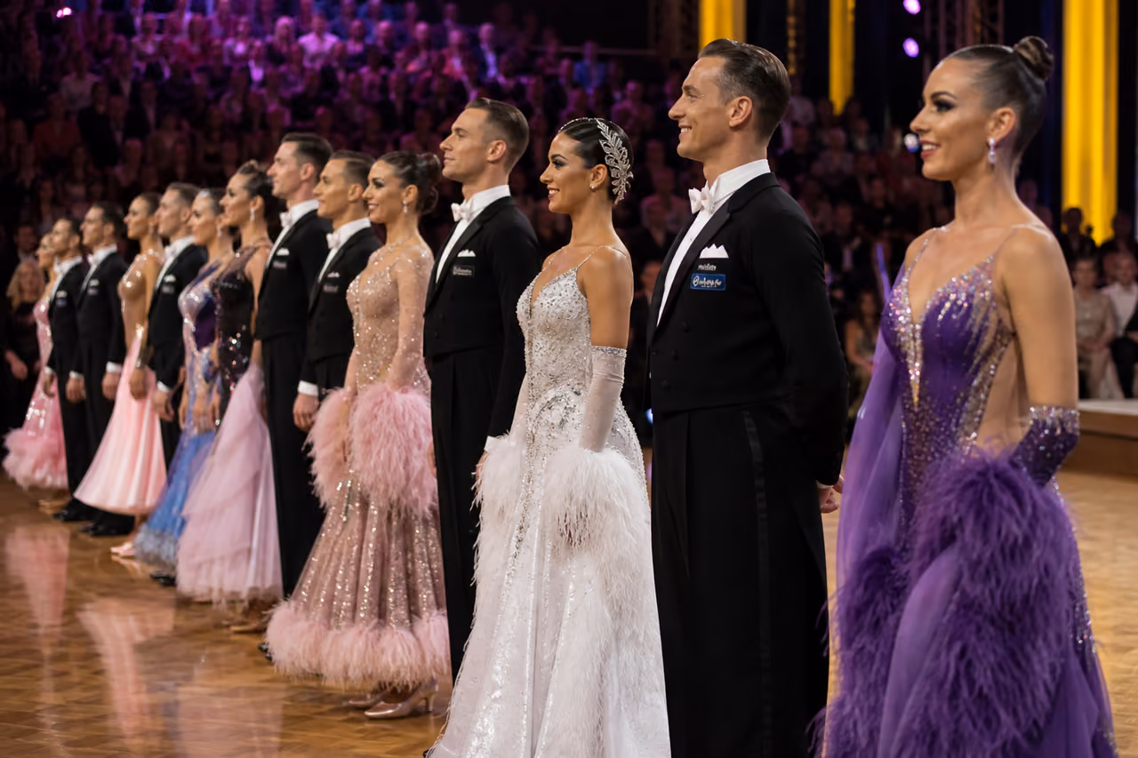 Diverse Group of Ballroom Dancers on a Glittering Competition Stage