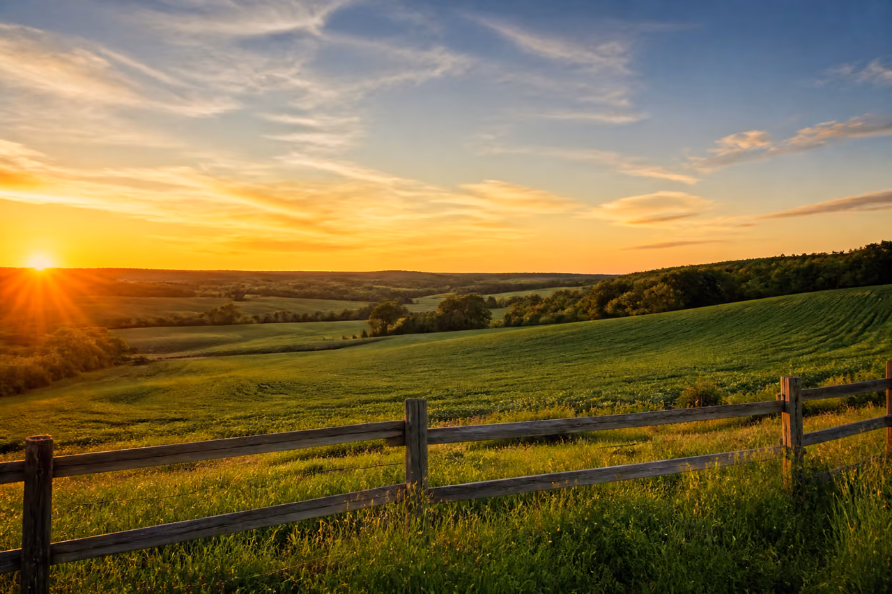 Lush Green Countryside Land with Rustic Wooden Fence