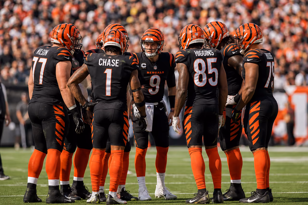 Professional Football Team Huddling on a Stadium Field