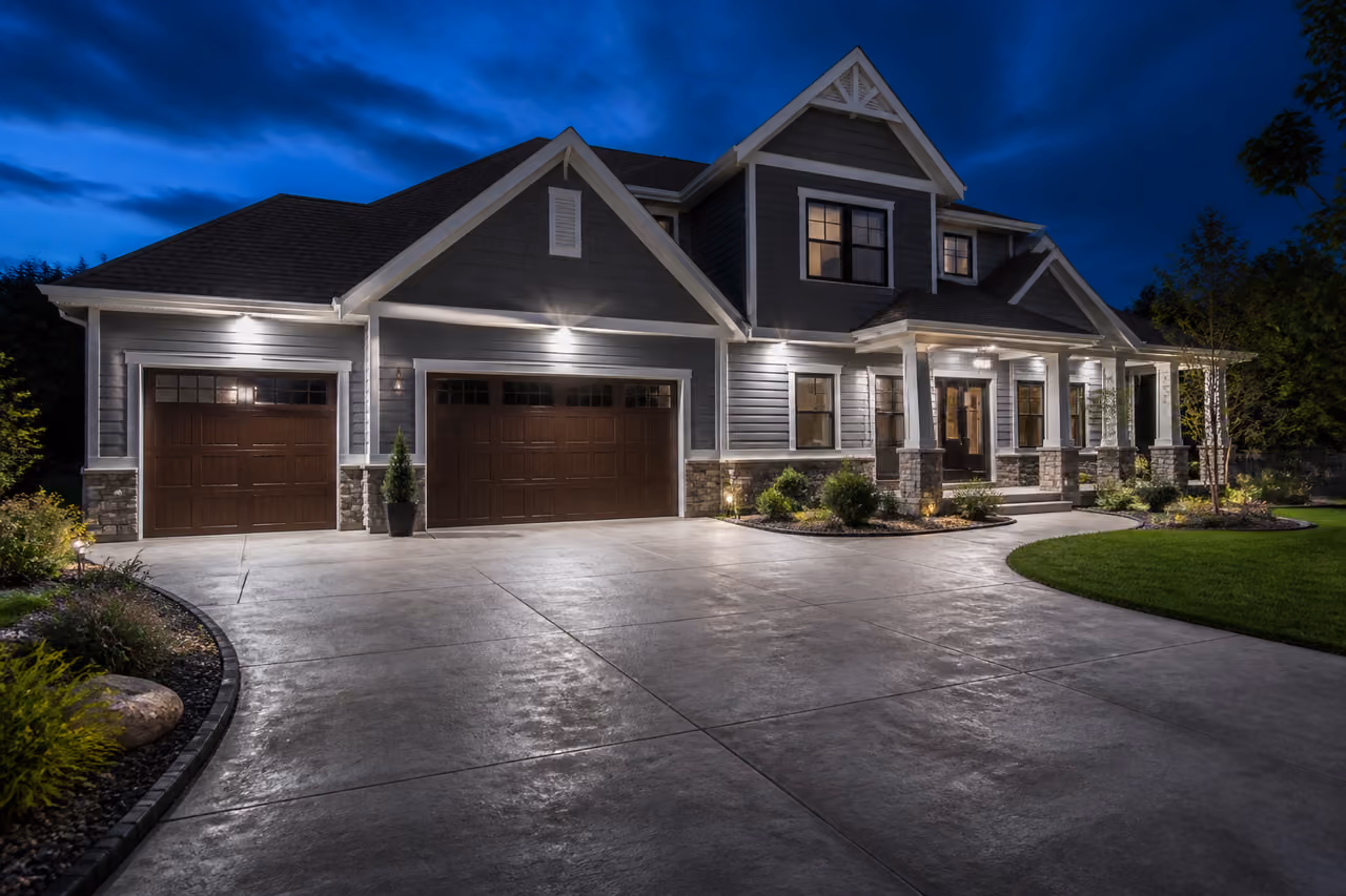Bright Exterior Residential Flood Lights Illuminating a Suburban Home Garage at Dusk