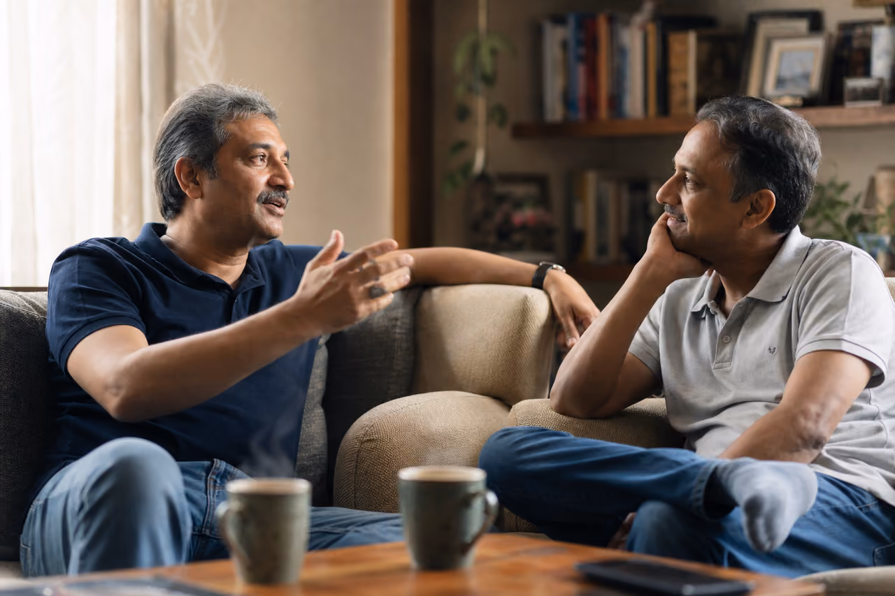Two Friends Reminiscing and Talking in a Cozy Living Room