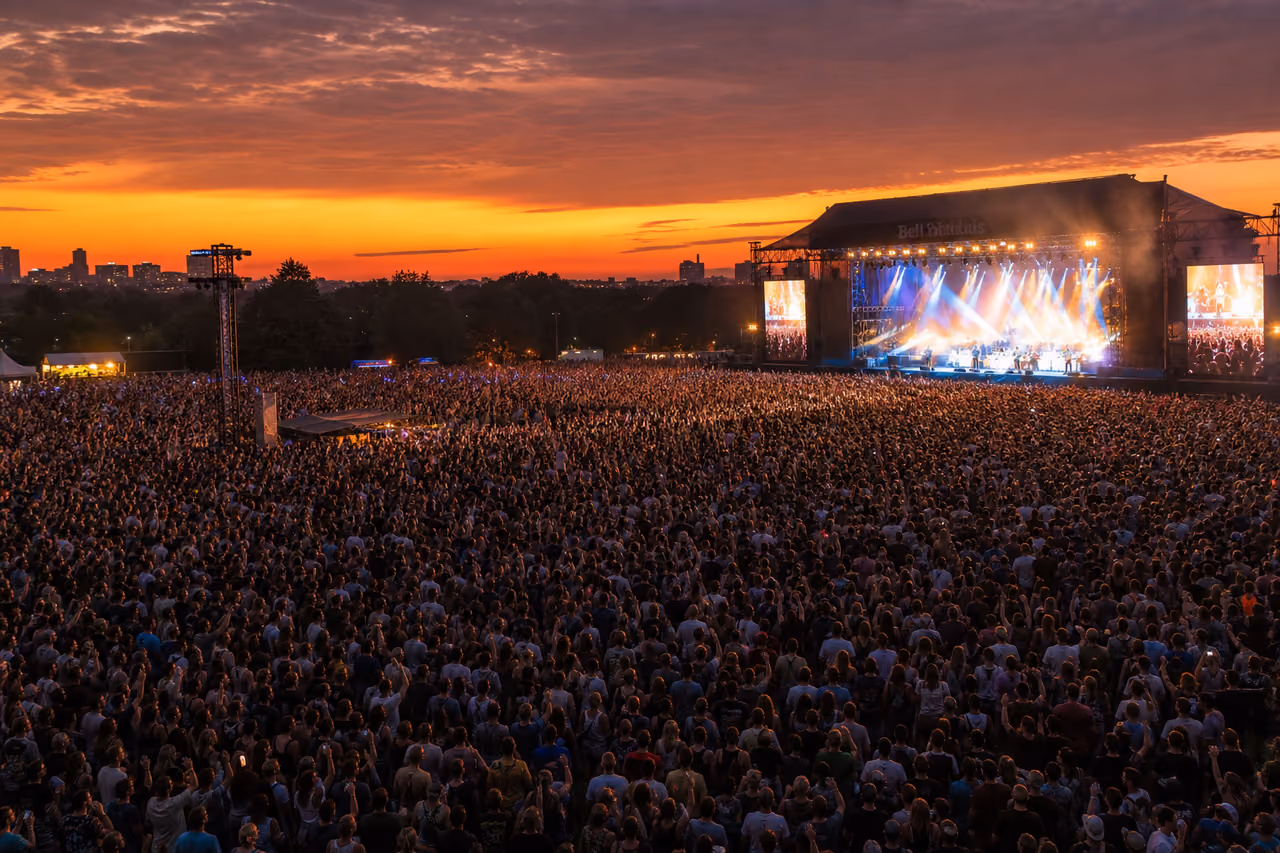 Crowd Cheering at an Outdoor Music Festival Stage