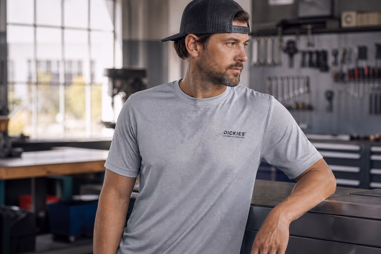 Man Wearing Dickies Advance Cooling Tee in Industrial Workshop