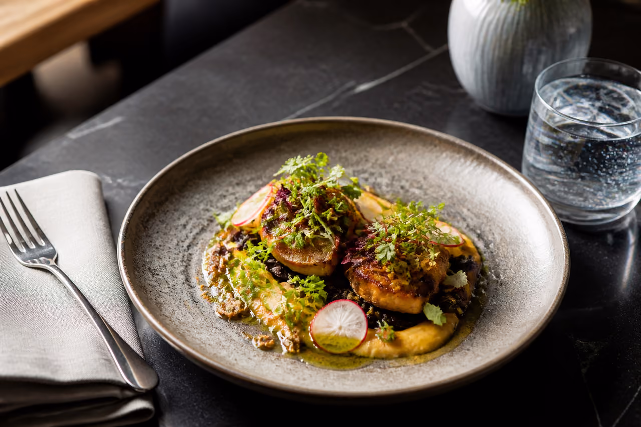 Gourmet Alivanca Jamilacuisine Plated on a Dark Slate Table