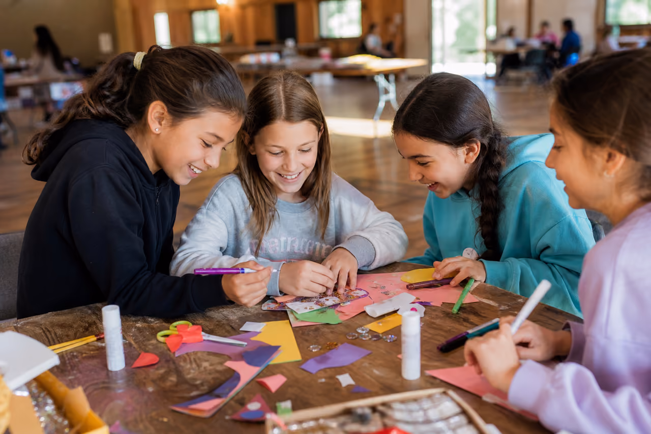 Young Girls Working on Craft Project in Community Hall