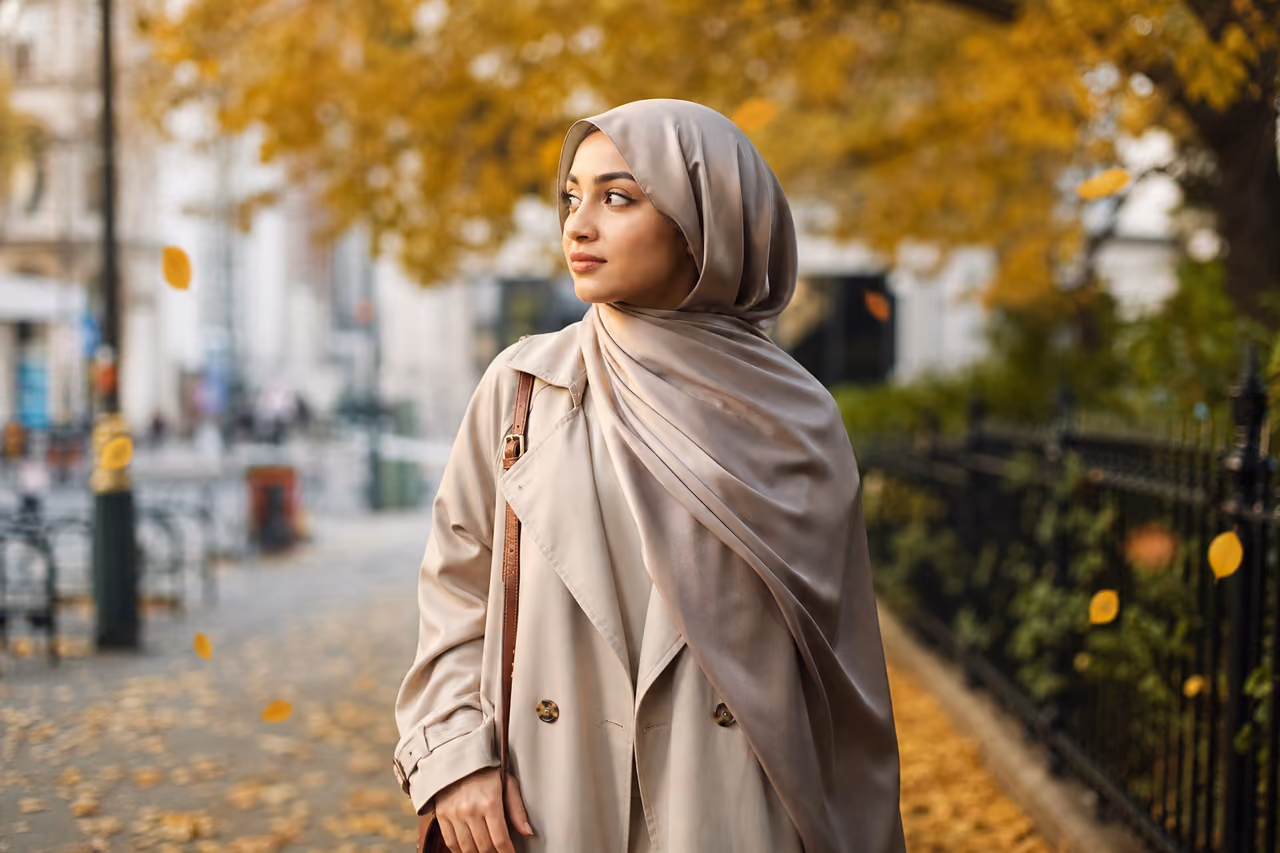 Muslim Woman Wearing a Silk Hijab in an Autumn Park