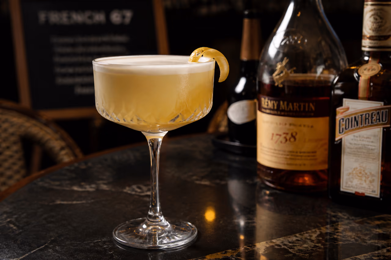 French 67 Drink in a Crystal Coupe Glass on Marble Bar