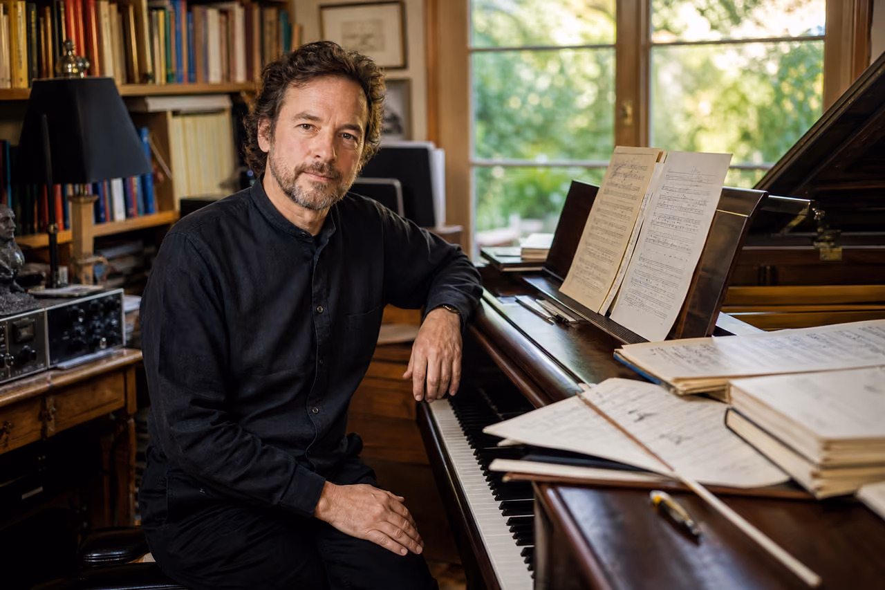 Composer Working on Musical Scores at a Grand Piano