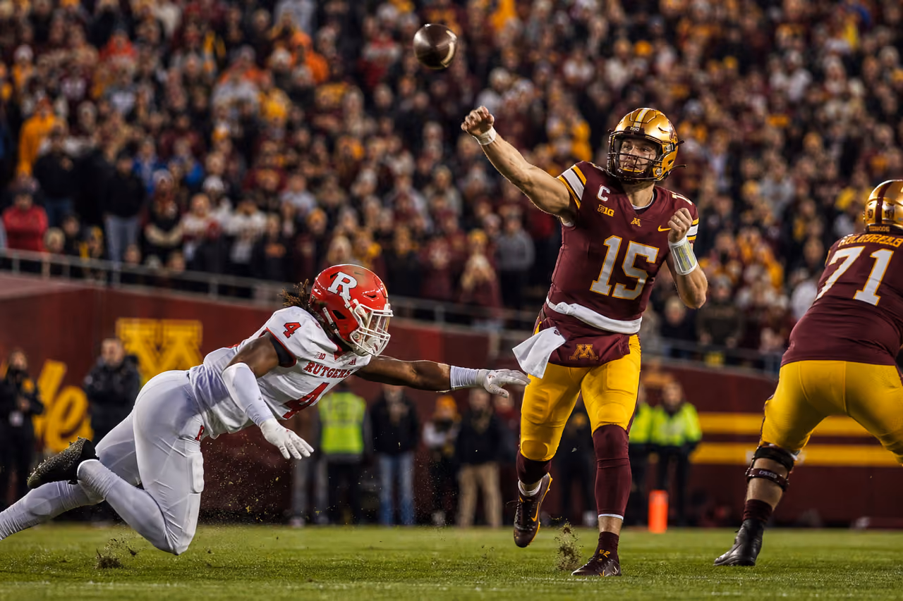 College Football Quarterback Throwing Pass During Week 10 Game