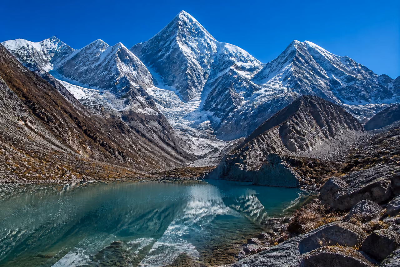 Snowy Peaks and Glacial Lake in a Massive Mountain Range