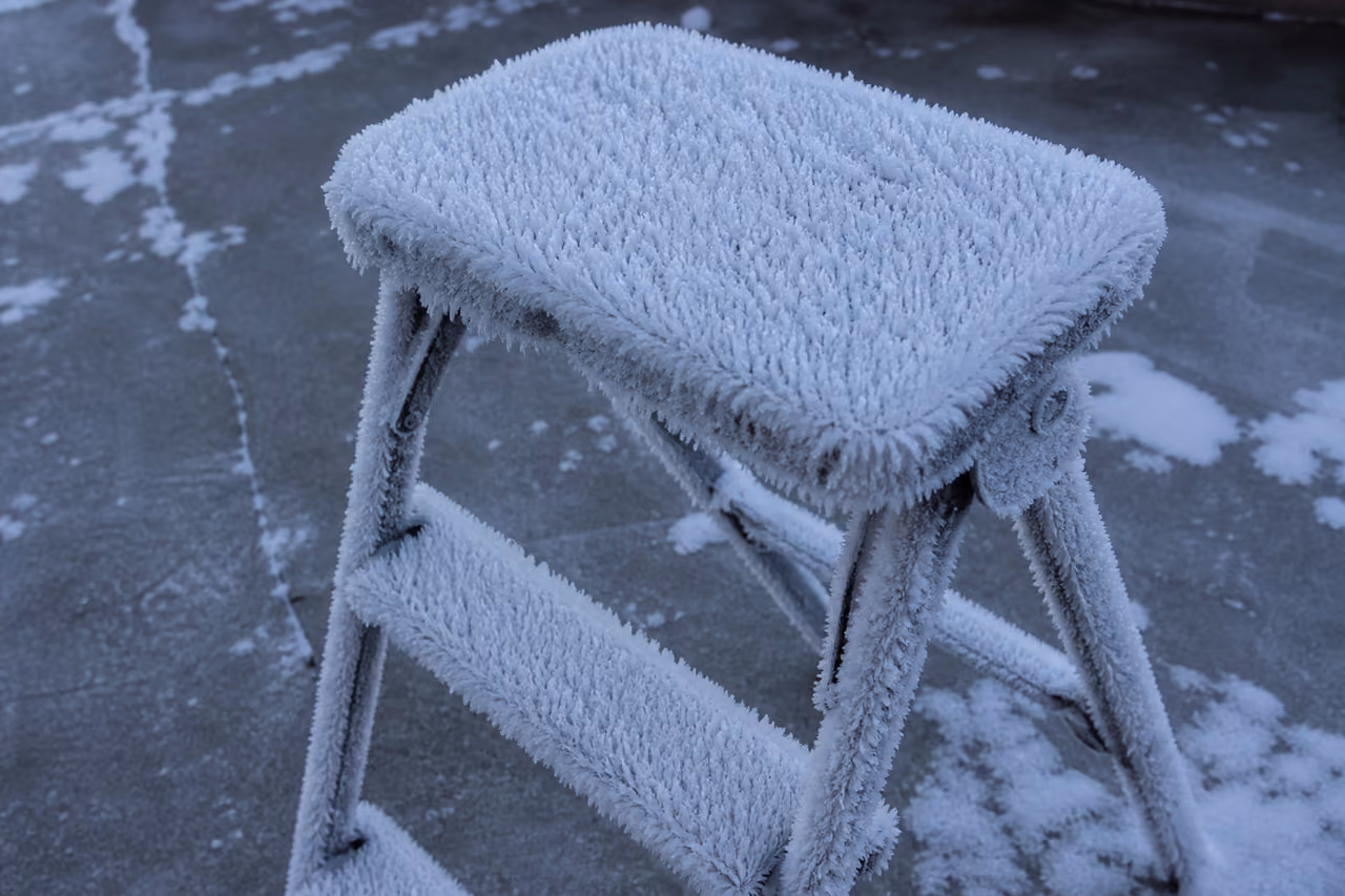 Metal Folding Step Stool Covered in Winter Frost