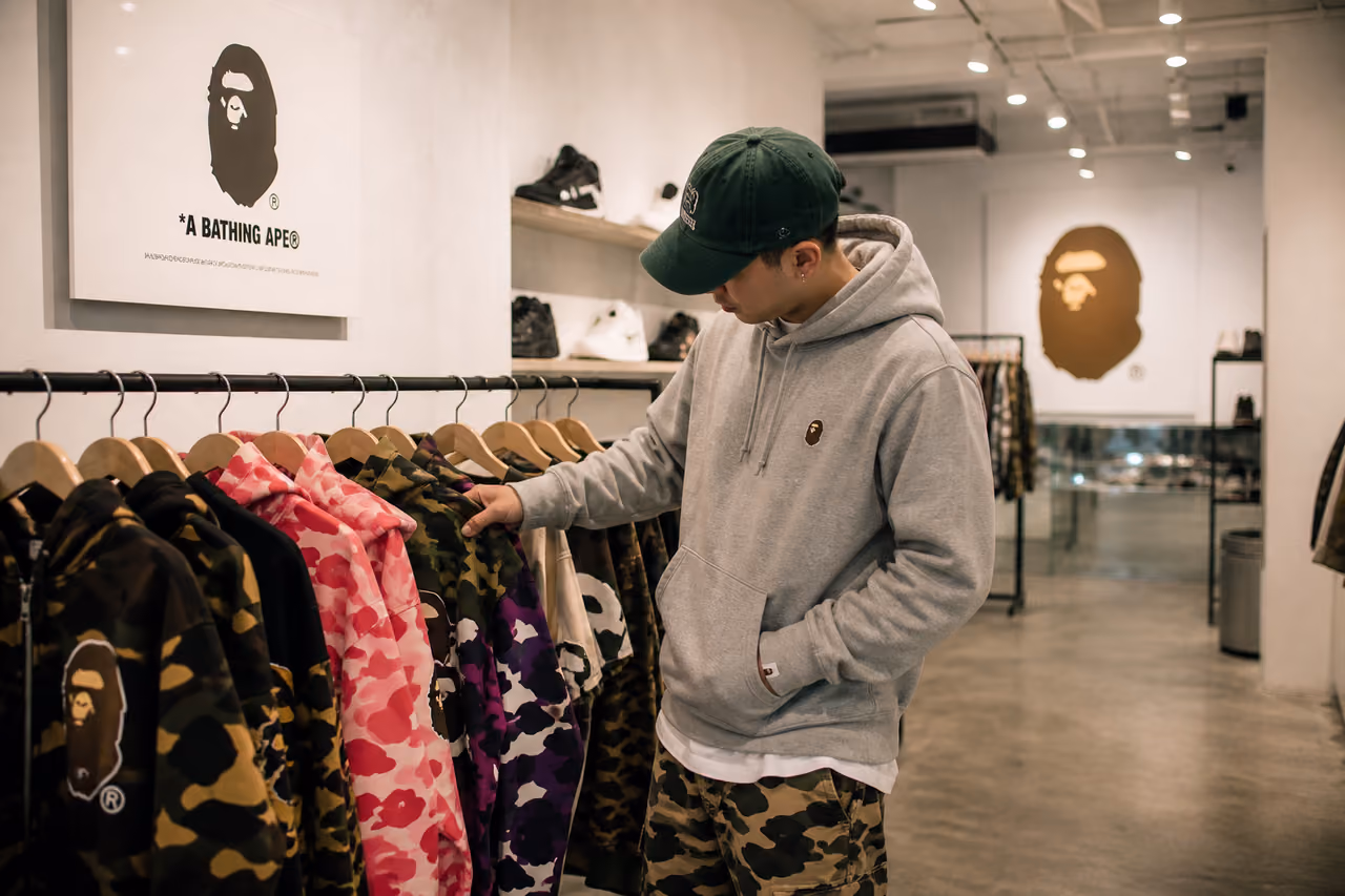 Customer Browsing Streetwear Apparel in a Modern Urban Boutique