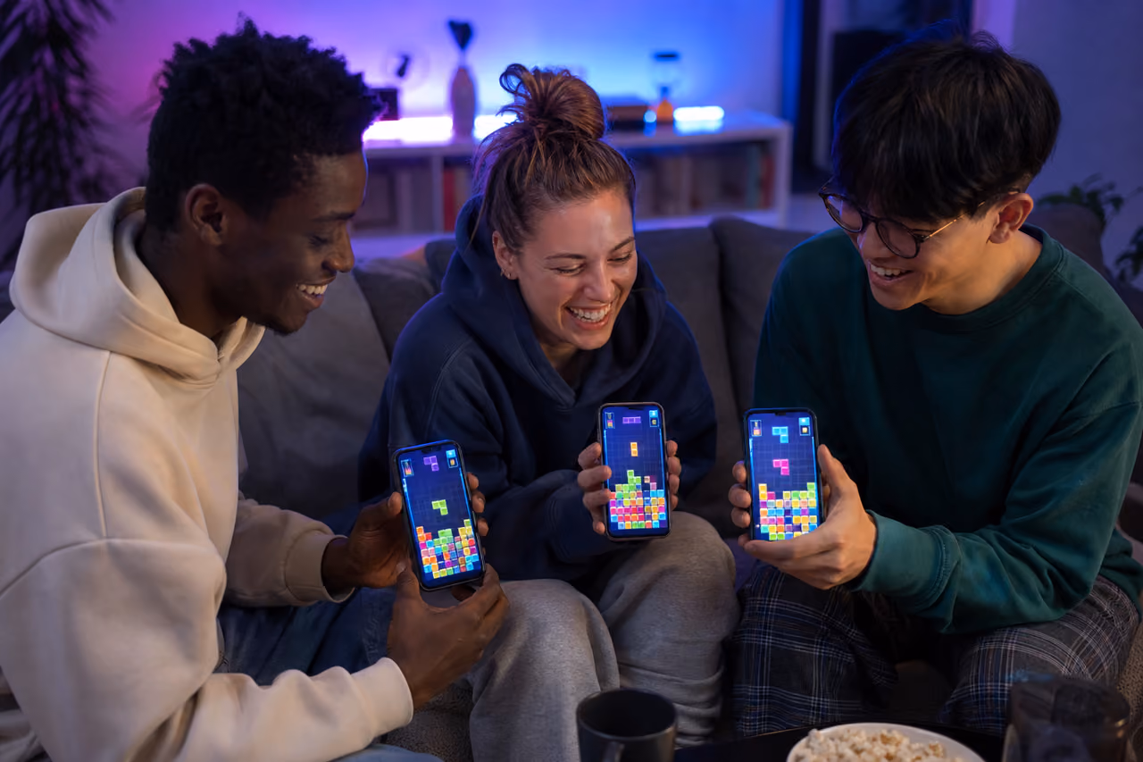Friends Playing a Block Puzzle Game on Smartphones