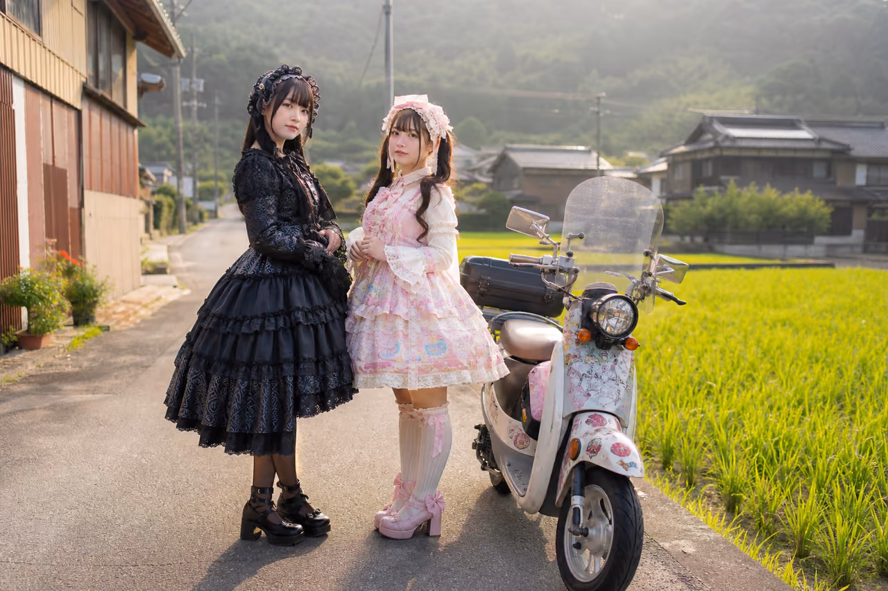 Two Women in Lolita Fashion Standing by a Scooter in Rural Japan