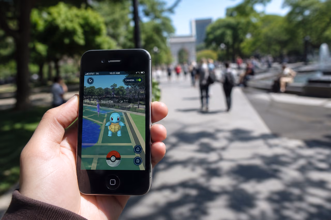 Hand Holding Iphone 4 Playing Augmented Reality Game Outdoors