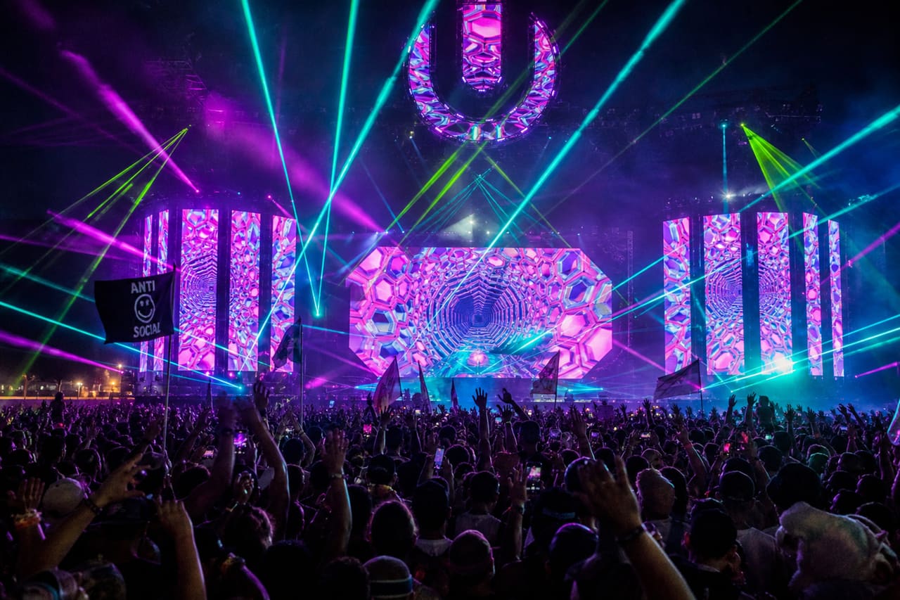 Crowd Dancing at Electronic Music Festival with Laser Lights