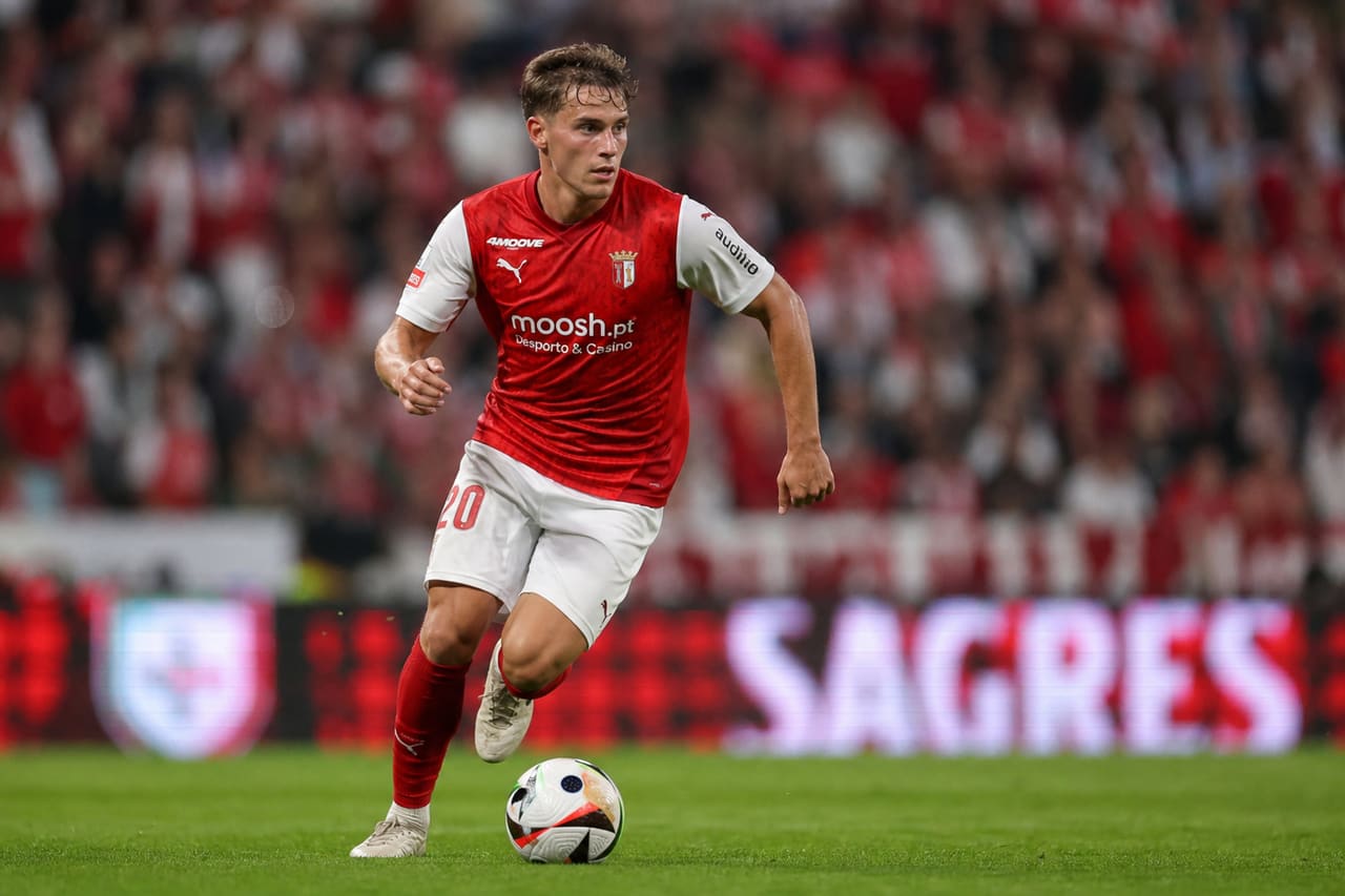 Professional Soccer Player Dribbling Ball on Stadium Pitch