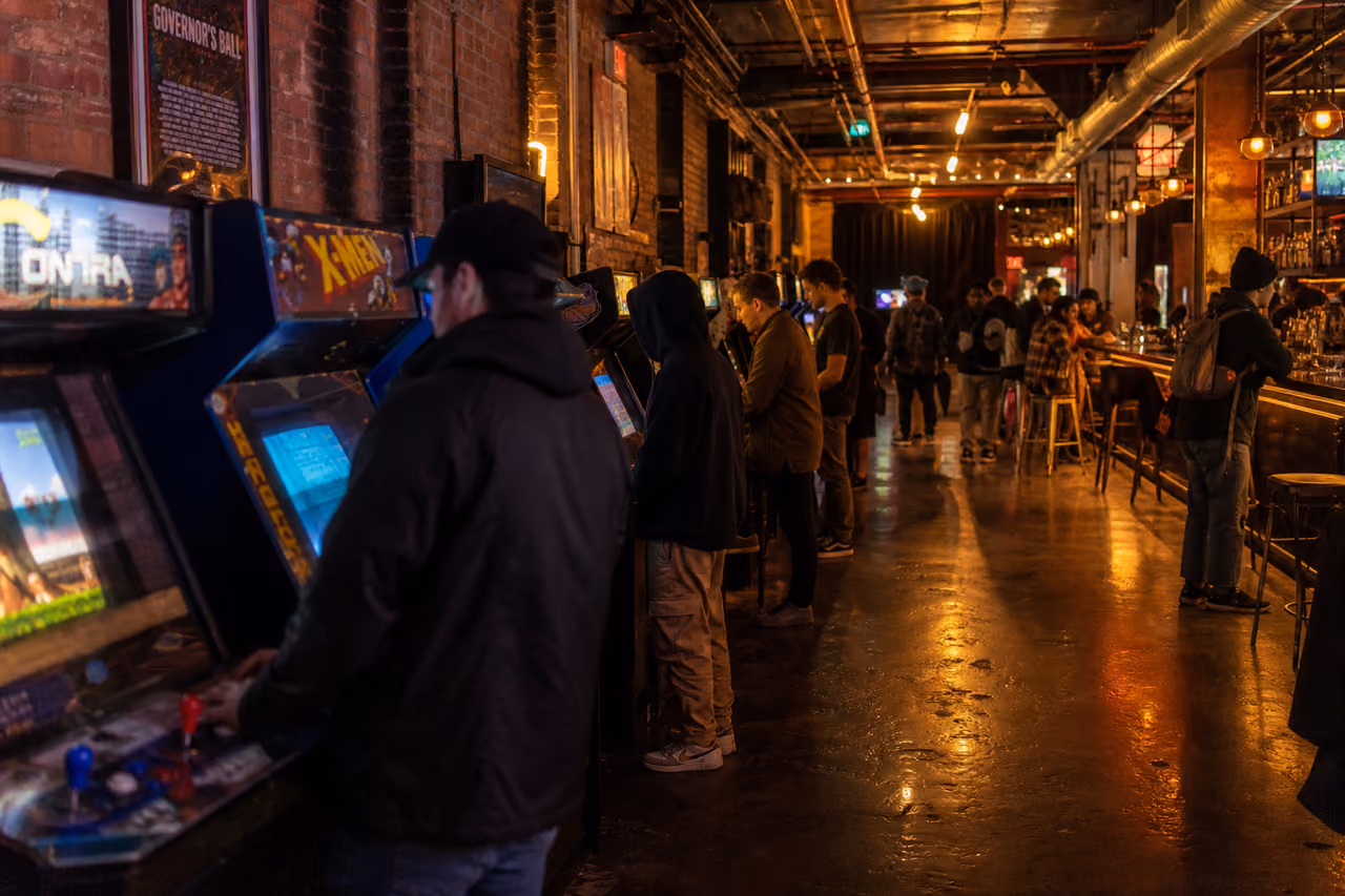 People Playing Vintage Arcade Games at a Brooklyn Barcade