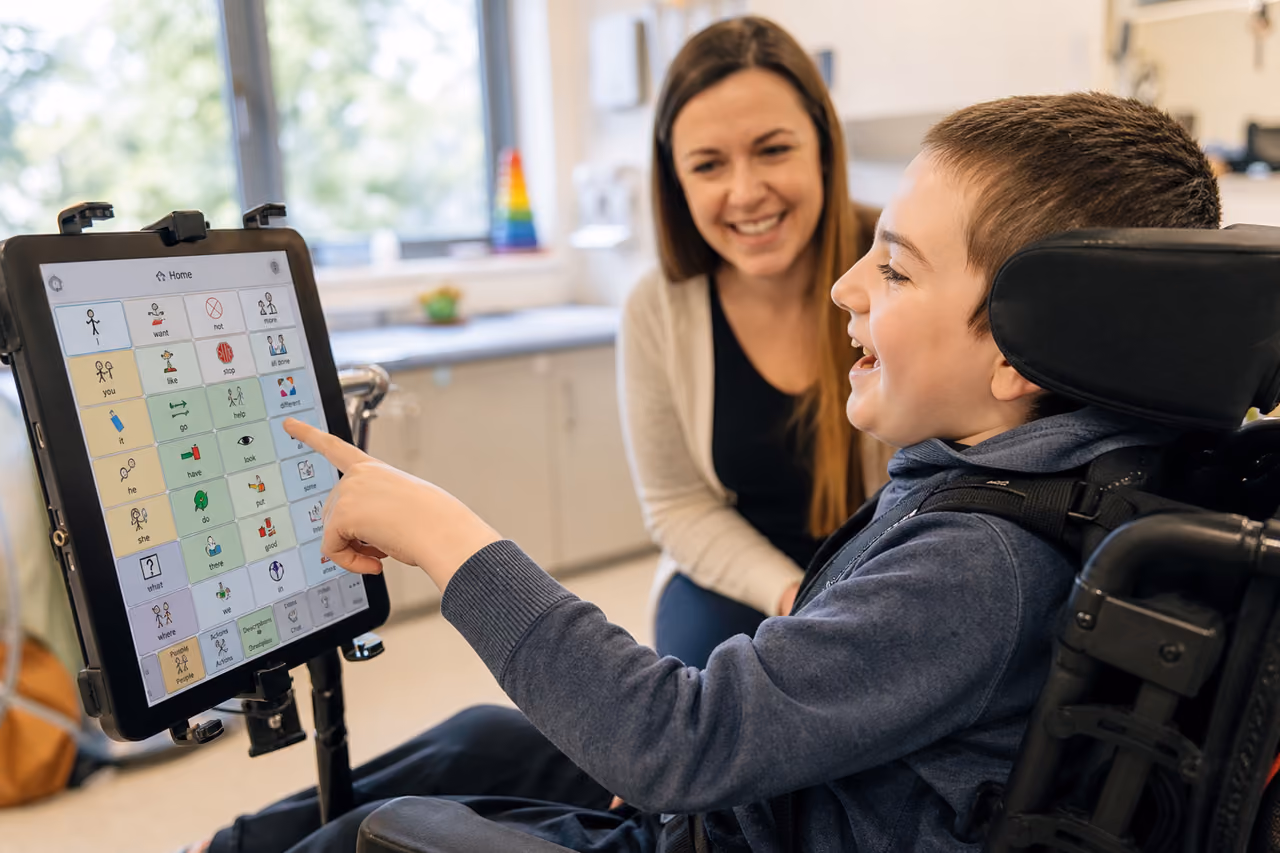 Child Using Communication App on Tablet in Pediatric Clinic