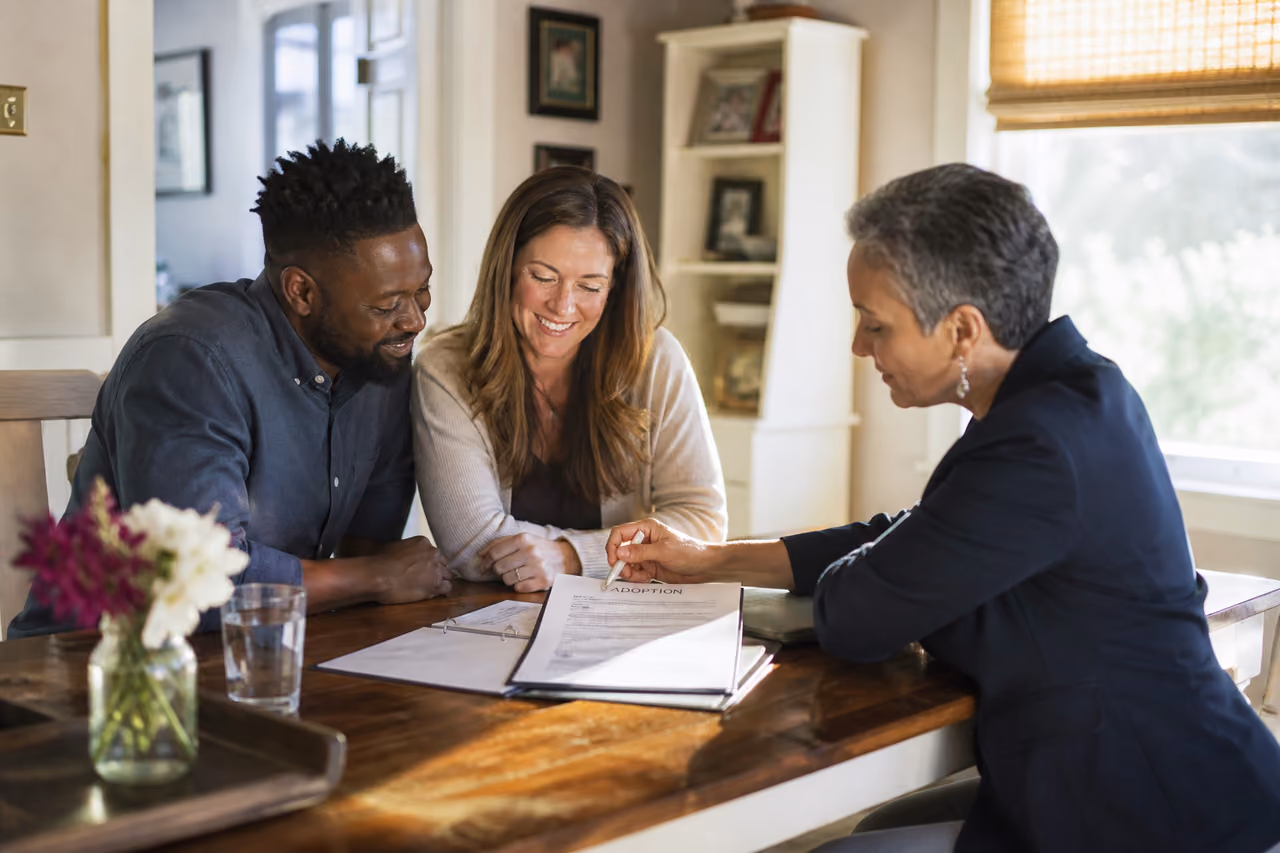 Adoptive Parents Reviewing Legal Documents with a Social Worker