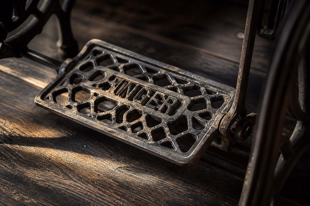 Antique Singer Sewing Machine Foot Pedal on Hardwood Floor